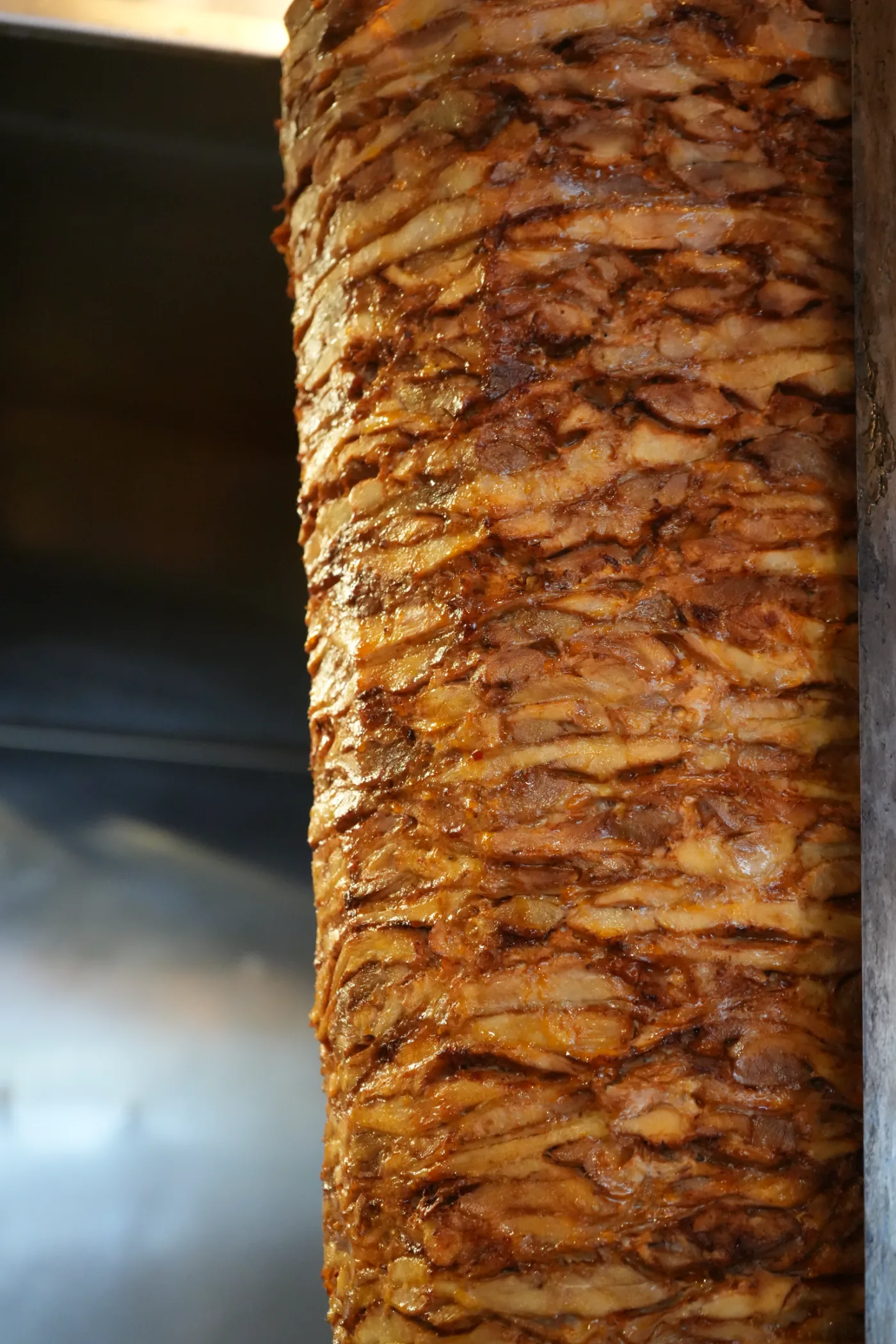 Chicken doner on the spit — hand-stacked, marinated, cooked daily